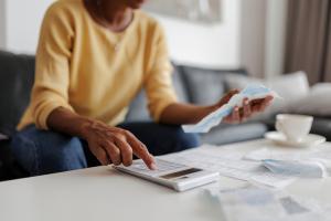 Woman with calculator and bills