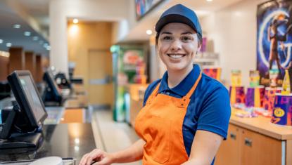 Female restaurant cashier smiling
