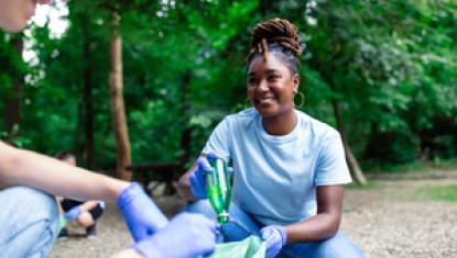 Teen volunteering outdoors with clean-up